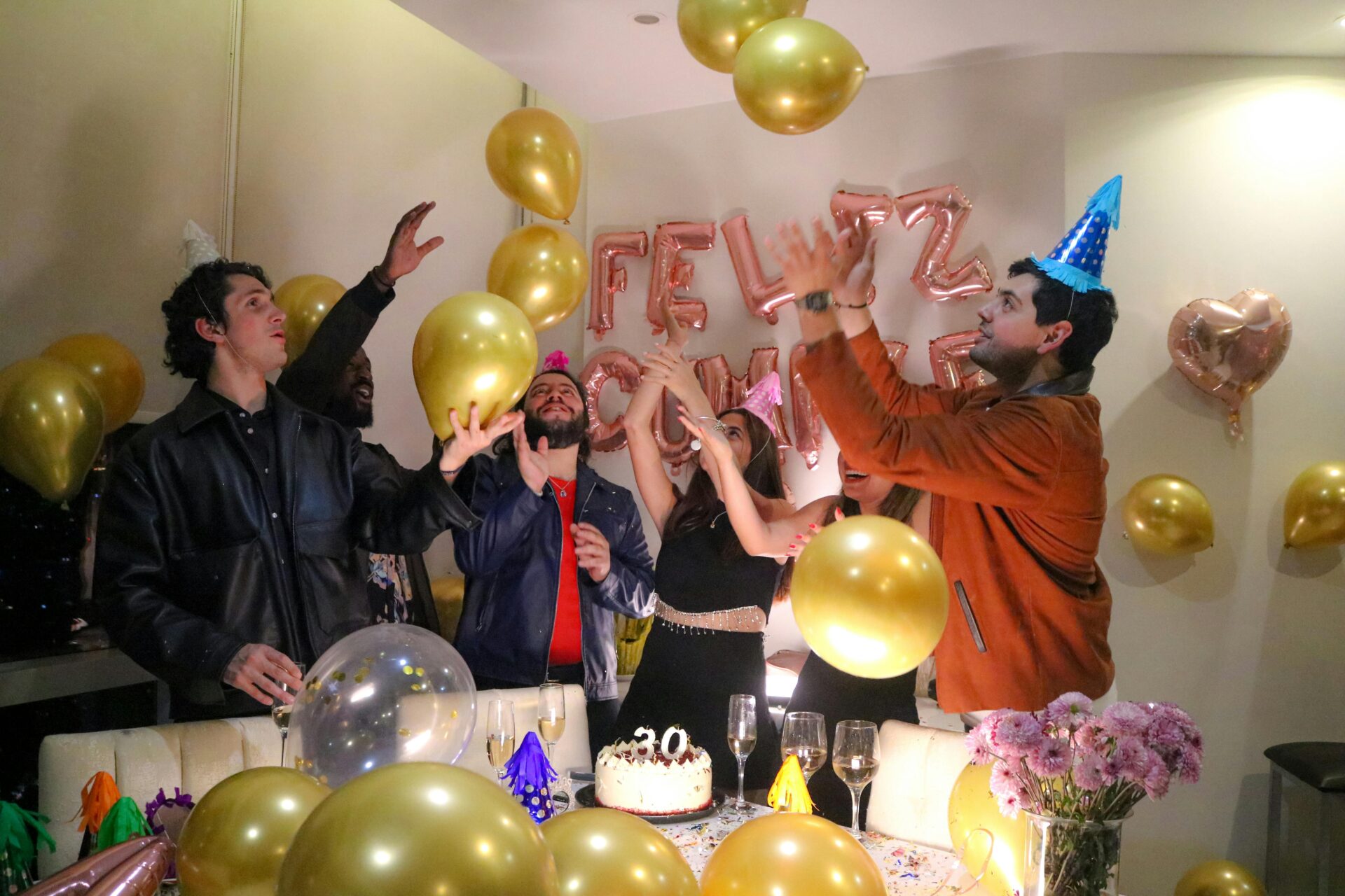 Lebendige Geburtstagsparty mit Freunden, die inmitten von Luftballons und festlicher Dekoration feiern.